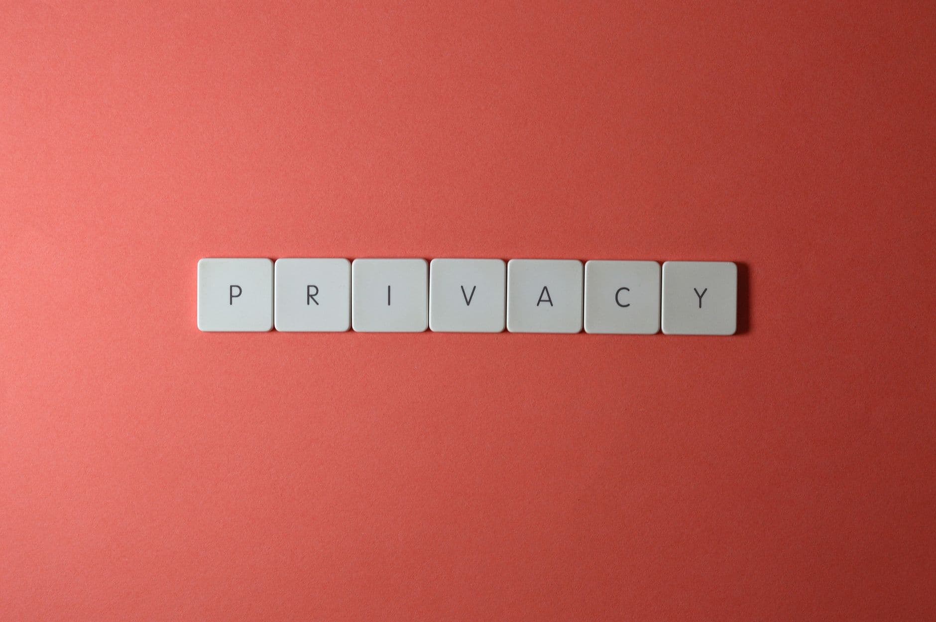 Letter tiles spelling PRIVACY on a red background